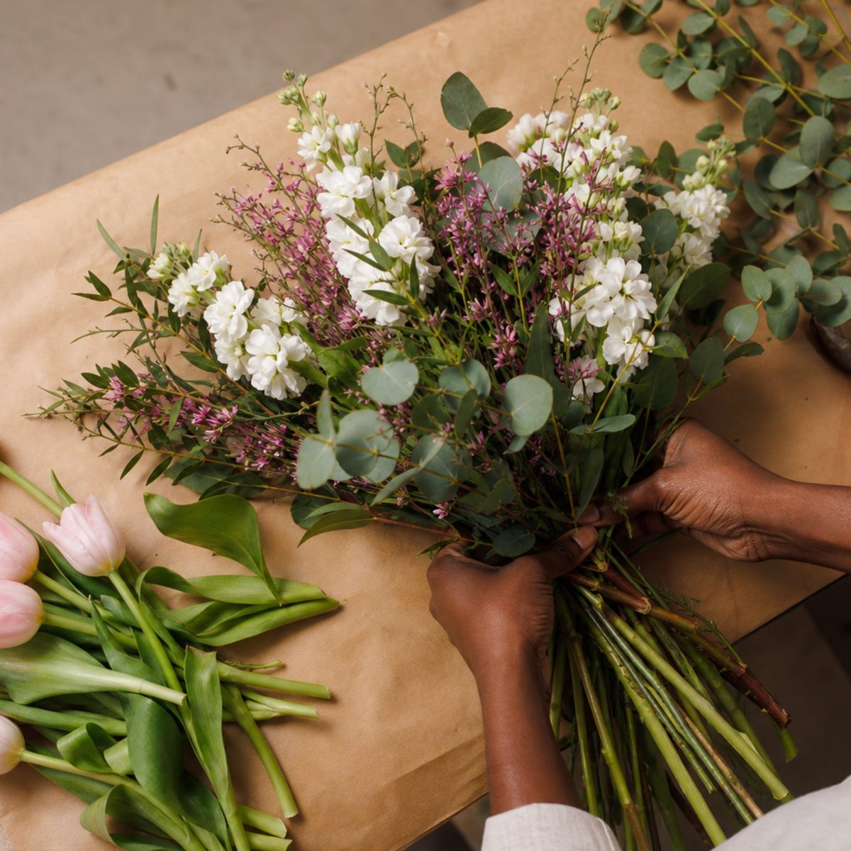 Florist tying a bouquet in the studio